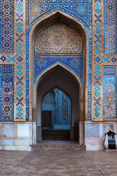 Ornate tiled archway at Shah-i-Zinda necropolis in Samarkand featuring intricate blue and turquoise mosaics. Ideal for travel, heritage, and Islamic architecture publications.