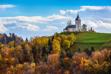 Naklejka premium Church on top of the hill in Slovenia countryside