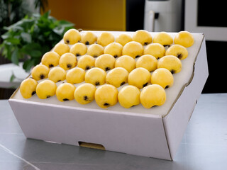 Fresh Suzhou Loquat Fruits in White Box - Yellow Golden Jade Fruit Display © CaoVan