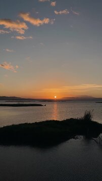 Timelapse of Sunset Over Calm Water With Clouds