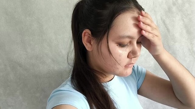 Woman feeling unwell and checking forehead for high temperature, flu symptoms, viral infection and seasonal illness concept.