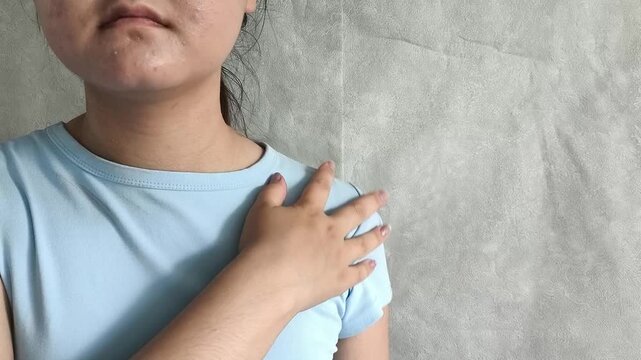 Woman stretching and touching shoulder after computer work, office fatigue, muscle tension, back pain and sedentary lifestyle concept.