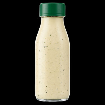 Glass bottle of creamy ranch dressing with green cap, condiment for salads and dips