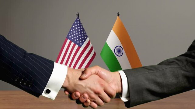 Global Diplomacy Concept Featuring Handshake Between American and Indian Delegates with National Flags in Background