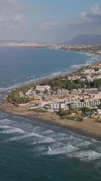 Vertical aerial, panoramic view of the northern coast of the island of Crete near the town of Agia Marina and Platanias, Crete, Greece
