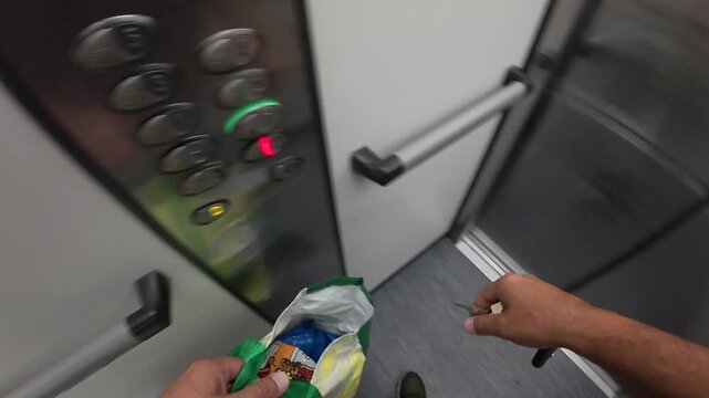Point of view shot of man using an elevator after shopping
