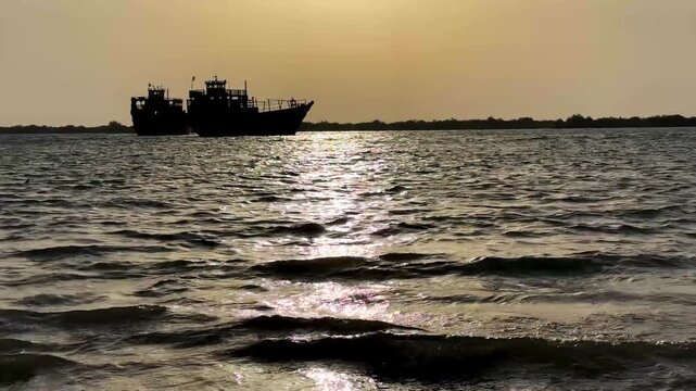 Ship sea wave Golden sunset in UAE dhows Qatar traditional water transport maritime old wooden sailing boat floating in Iran Qeshm in calm evening fishing seascape silhouette sunlight travel vacation