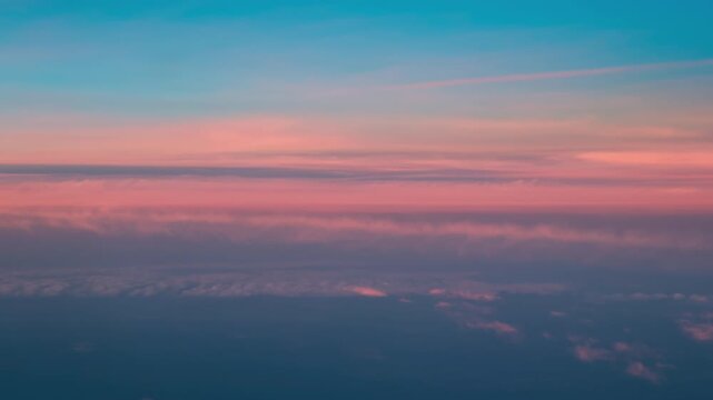 Soft pink cloud bands and blue gradients creating atmospheric sky backdrop