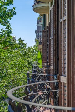 Traditional Apartment Balconies With Wooden Shutters In Barcelona, Eixample District, Wrought Iron Railing