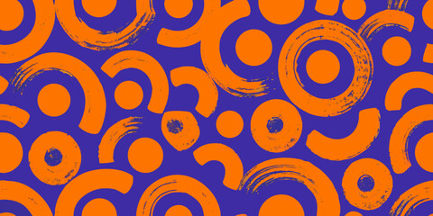 Fototapeta premium Orange circular shapes seamless pattern on purple background