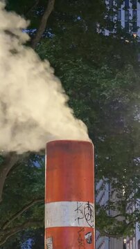 Close-up of steam escaping from a street utility vent.