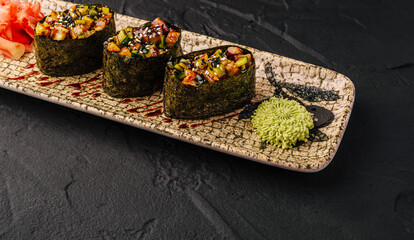 Gunkan maki sushi on textured plate with wasabi © AntAlexStudio