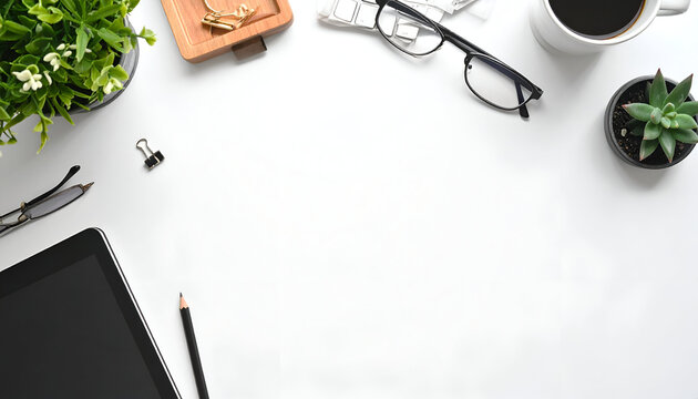 White workspace with office supplies plants, glasses, coffee, tablet, and stationery