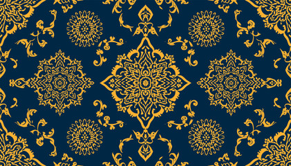 Elegant seamless pattern with intricate golden floral and mandala motifs on a rich dark blue background, evoking a luxurious textile design. © abi