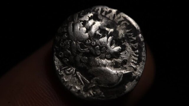Silver Roman Denarius on video. Septimus Severus emperor. Portrait, bust on an ancient coin. Close up, shifting lights