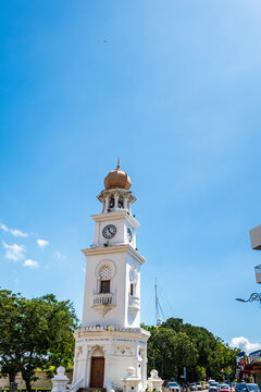 Penang, Malaysia - June 20, 2026: Queen Victoria Memorial Clock Tower in George Town, Penang, Malaysia, with street and buildings in background.