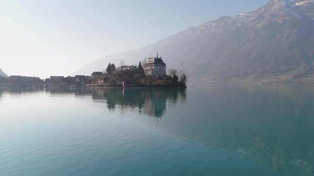 Found in Iseltwald, Switzerland. The prominent building situated on the peninsula directly on Lake Brienz is Schloss Seeburg or Seeburg Castle.