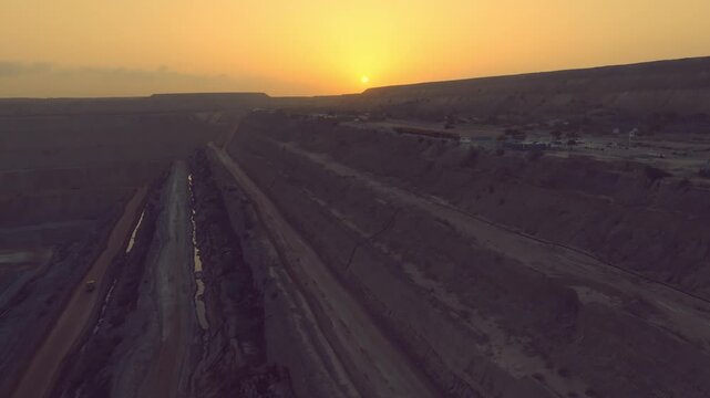 Breathtaking aerial footage captures the vast Thar mining project in Sindh, Pakistan, with heavy trucks operating under a stunning golden sunset.