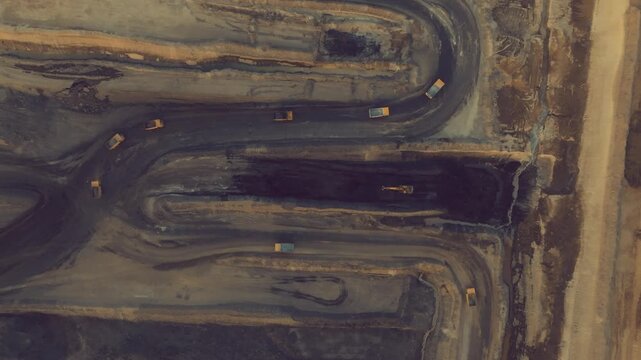 Aerial drone footage captures the extensive Thar coal mining project, with trucks moving materials in Sindh, Pakistan.