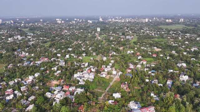 Cnematic aerial of Aluva featuring vibrant riverside settlements, lush vegetation, and the picturesque Periyar River creating a breathtaking panorama that reflects the natural and urban of Kerala