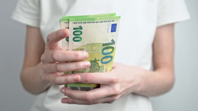 Female hands counting stack of euro banknotes isolated on white background. Financial planning, savings, cash payment, investment and money management concept.	