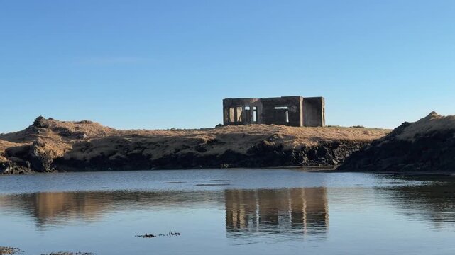 Pond With A Reflection Of Thorshammar, &THORN;&oacute;rshamar Farmhouse In Hopsnes, Grindavik, Iceland. - tilt up shot