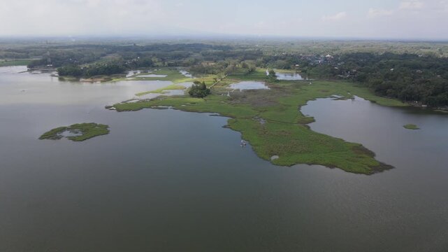 Aerial view of Mulur Reservoir, a natural tourist destination and reservoir, a Dutch heritage site built in 1926 in Sukoharjo, Central Java, Indonesia.