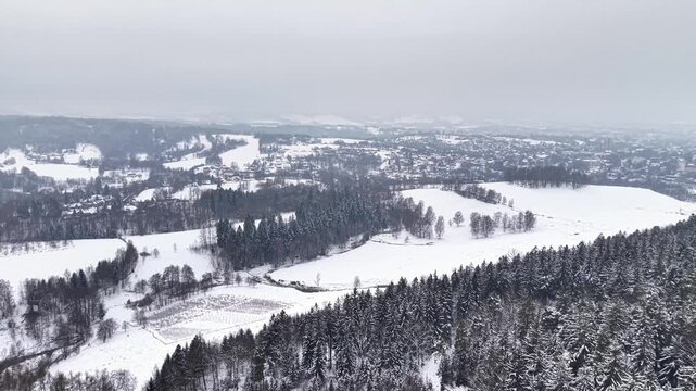 Frozen valley river winding through, patchwork snow fields, meandering stream, scattered farmsteads, low