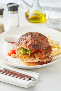 Chicken burger with pickled vegetables and fries, restaurant menu, comforting meal option