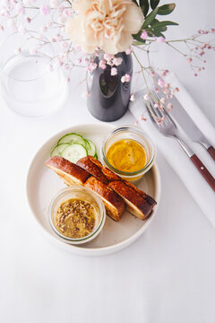 Homemade bread served with pickled cucumber and artisanal dips ideal for gourmet dining experiences or upscale restaurant menus