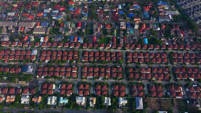 Bright suburban homes line tranquil residential street beneath clear, sunny sky, presenting serene and orderly neighborhood scene perfect for real estate or community lifestyle imagery.