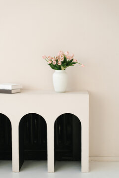 Pink Tulips In White Vase On Minimalist Arched Console Table