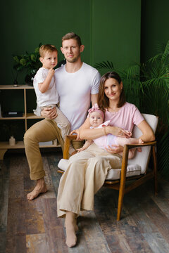 Parents With Son And Baby Girl In Living Room