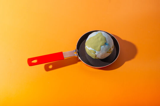 Planet Earth frying on a pan. Climate change and ecological catastrophe concept