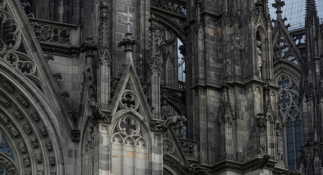 Gothic cathedral interior with stained glass and stone arches.