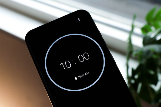 10-minute countdown on black phone background. Timer to study or be productive, on a interior green, blurry plants interior