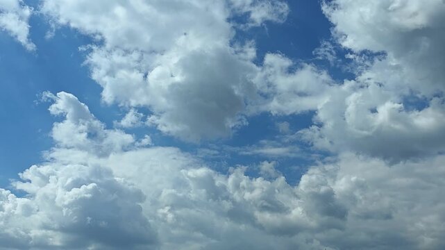 Amazing timelapse of Cumulus clouds forming in the blue sky, white giant fluffy clouds moving in summer day, 4K
