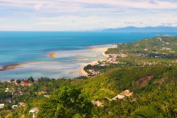 Fototapeta premium Samui Thailand - 27 June 2026 : Seascape Seen from Overlap Stone is located in Samui island Thailand - Famous check point in Samui island - Blue Nature Abstract background. This was on a hot sunny d