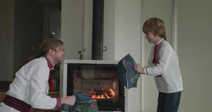 Man and Kid Boy Have Fun Playing Together on Floor Near Fireplace. 4K 10-bit
