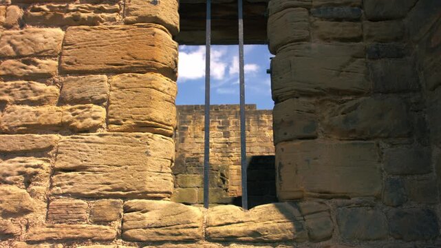 Prison bars on a stone wall