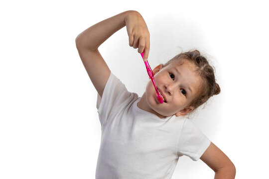 Young Girl Brushing Teeth with Pink Toothbrush Isolated on White Background