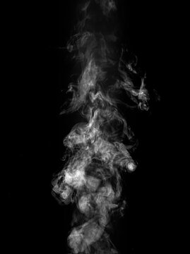 White smoke rises and swirls gracefully against a solid black background.