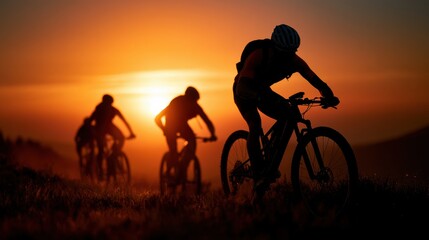 Obraz premium Silhouetted Bikers on Trail