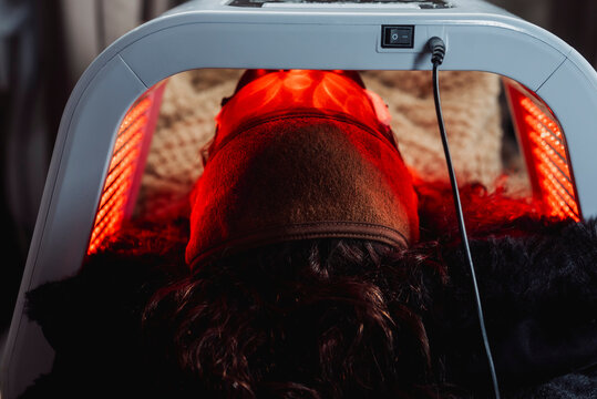 Client relaxes during a professional red LED light therapy facial designed to support skin rejuvenation, collagen production, and overall complexion improvement in a medical spa.