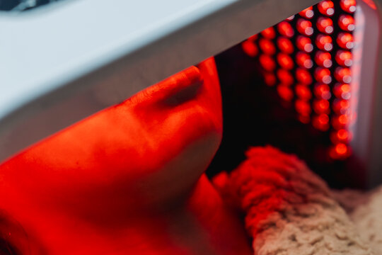 Client relaxes during a professional red LED light therapy facial designed to support skin rejuvenation, collagen production, and overall complexion improvement in a medical spa.