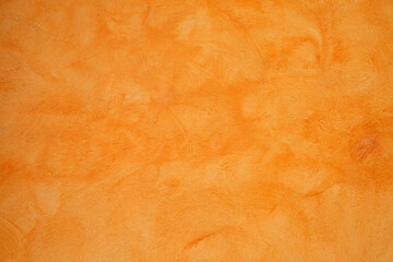 Fototapeta premium Soft burnt orange surface featuring gentle shading and grain