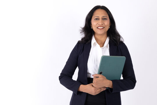 Mid shot of attractive indian business woman arms crossed looking to camera standing pose in black suit isolated on white studio background 