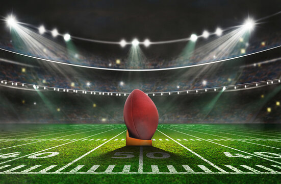green field in american football stadium. ready for game in the midfield