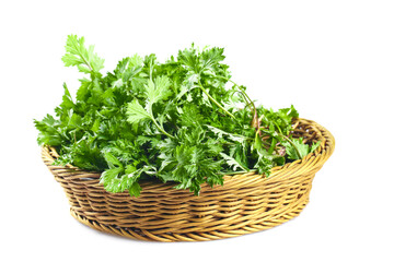 Naklejka premium Fresh Mugwort Greens in Woven Basket - Qingming Festival Herbs