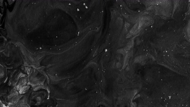 Soft, organic fluid swirls, dark gray color gradations, and touches of white splashes or speckles resembling stars in the night sky or the natural grain of granite.